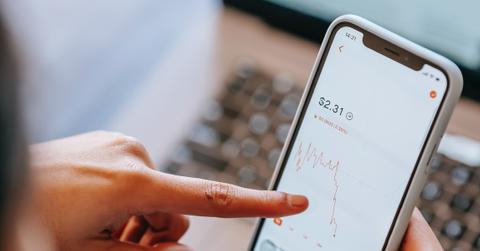 A person analyzing a graph on a smartphone