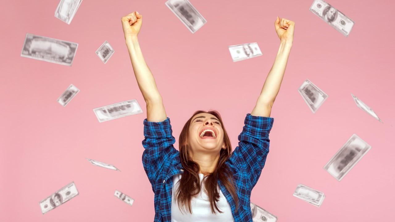 A young woman celebrating having savings for college