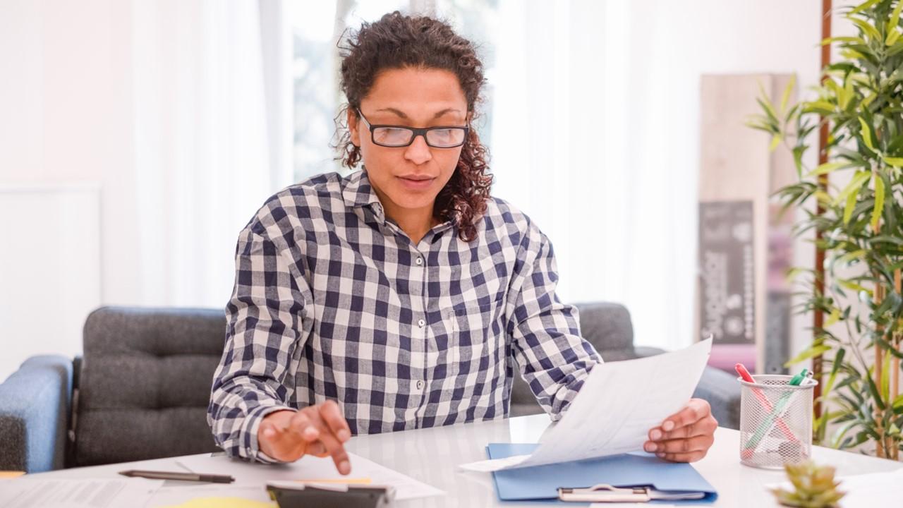 A woman calculating her long-term disability pay