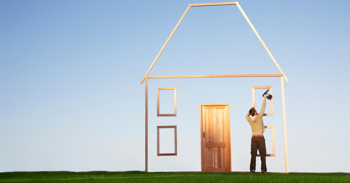 man drills house outline