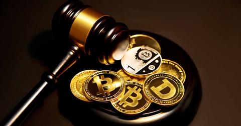 Crypto tokens next to a gavel