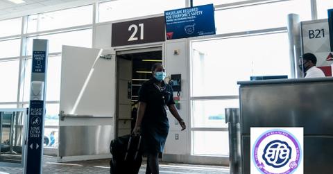 A Delta Air Lines flight attendant walking in an airport