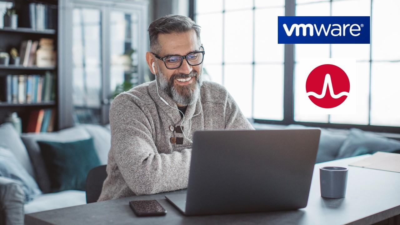 A man looking on a laptop and VMware and Broadcom logos