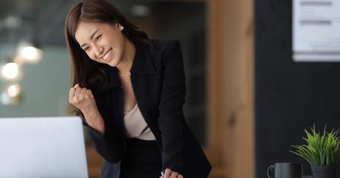 A woman in a black suit looking a Microsoft Rewards on her laptop