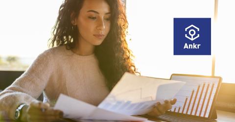 Woman looking at data and Ankr logo