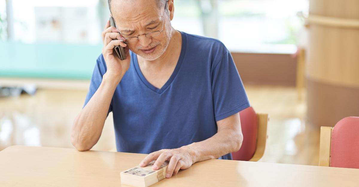 A man on the phone holding money