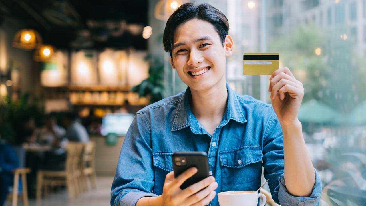 A man holding a debit or credit card