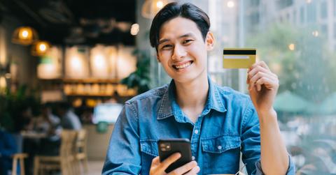 A man holding a debit or credit card