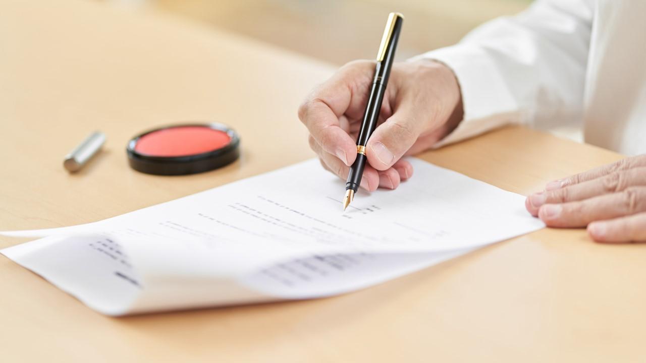 A man signing an estate plan