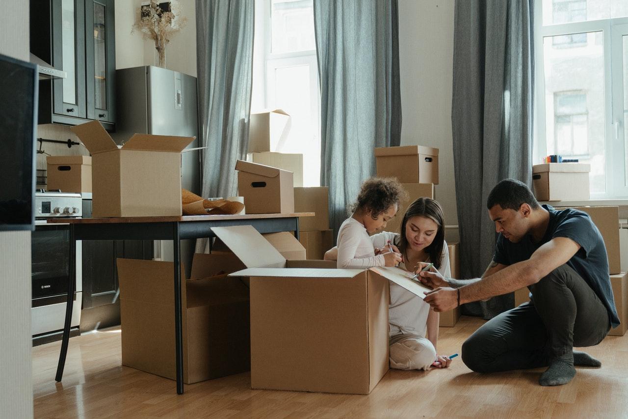 A family unpacking moving boxes