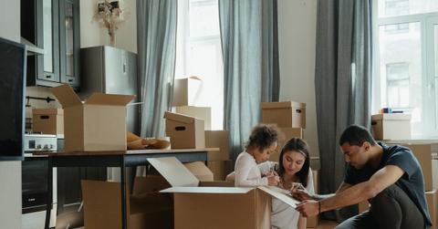 A family unpacking moving boxes
