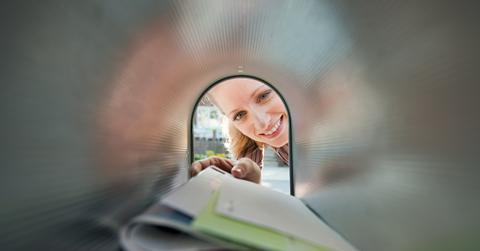 woman collecting mail from mailbox