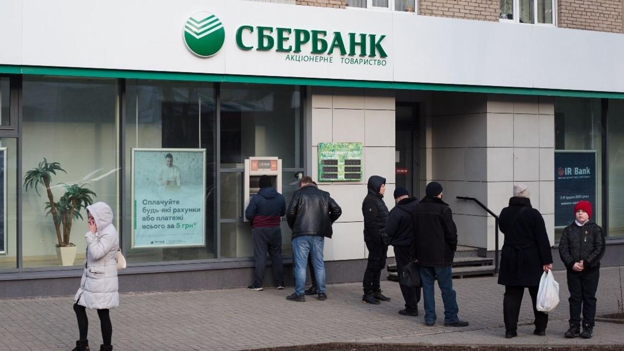 A line of people waiting at an ATM in Ukraine