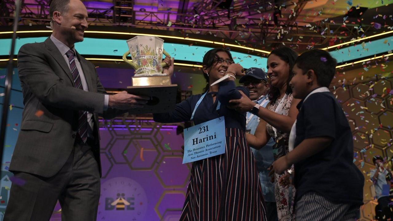 Harini Logan receiving the Scripps National Spelling Bee trophy