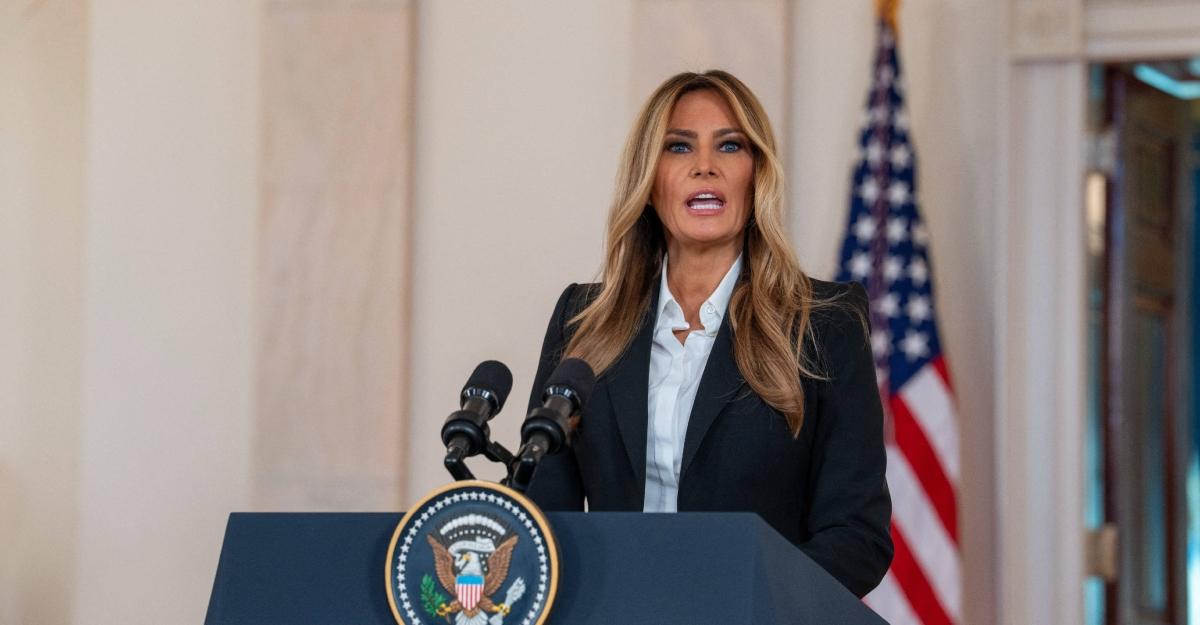 Melania Trump speaking in front of American flag