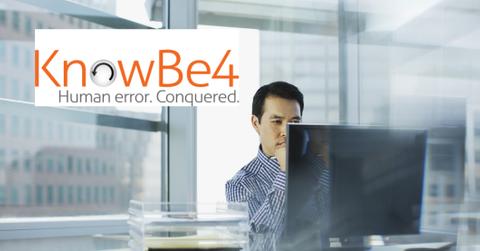 KnowBe4 logo over man on computer