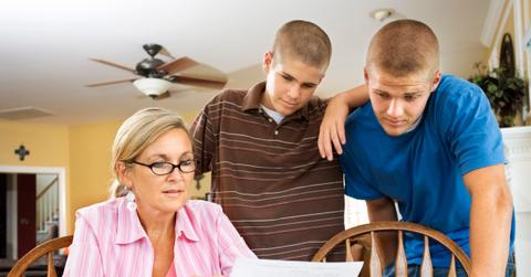 A mother and her sons looking a child support paperwork