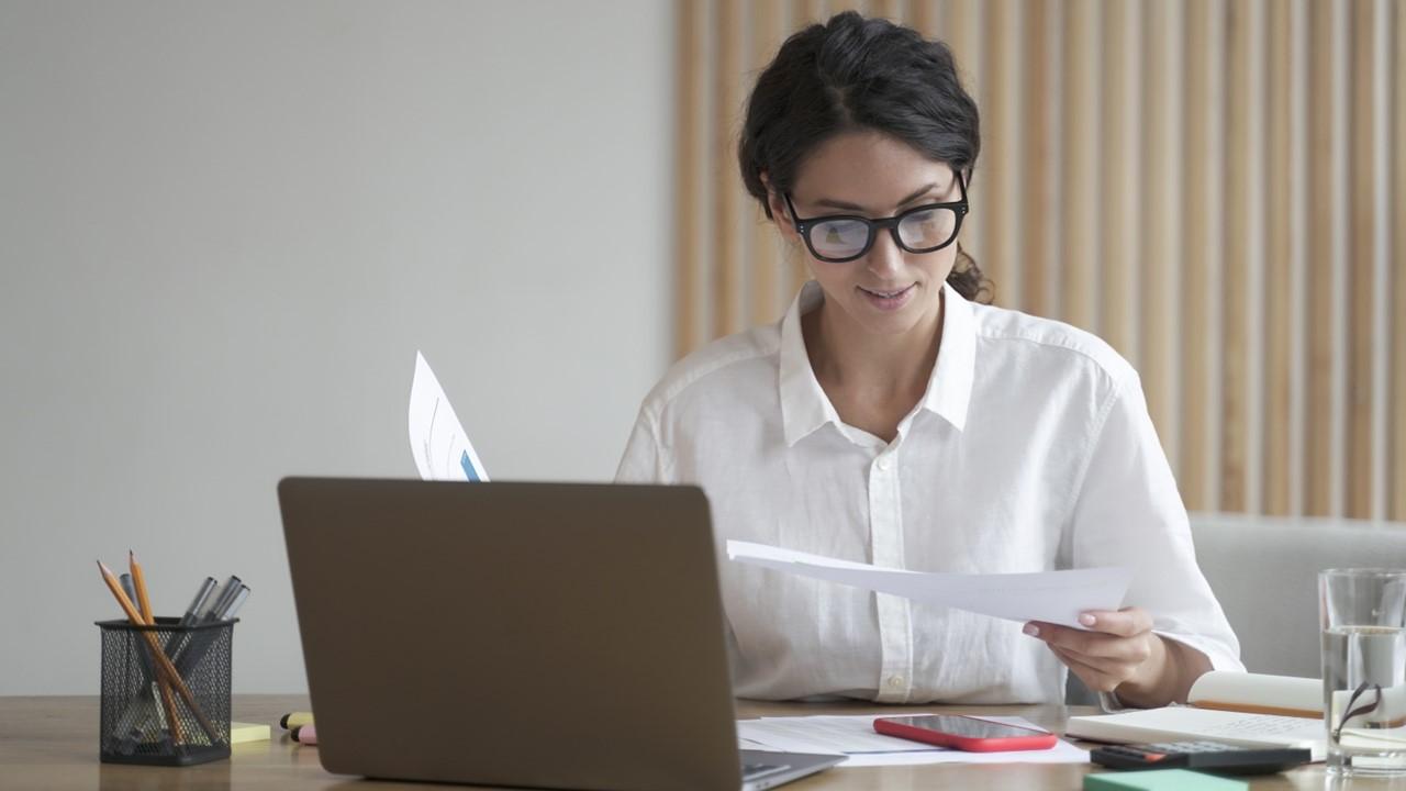 A woman looking at tax documents