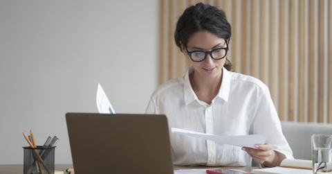A woman looking at tax documents