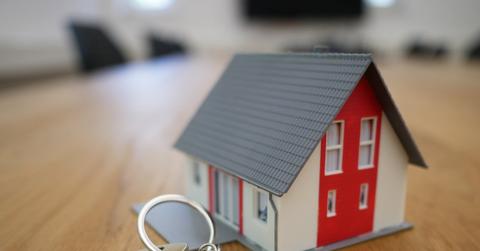 A miniature house and keys