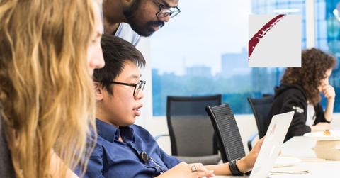 Bridgewater logo over people working at table with computer