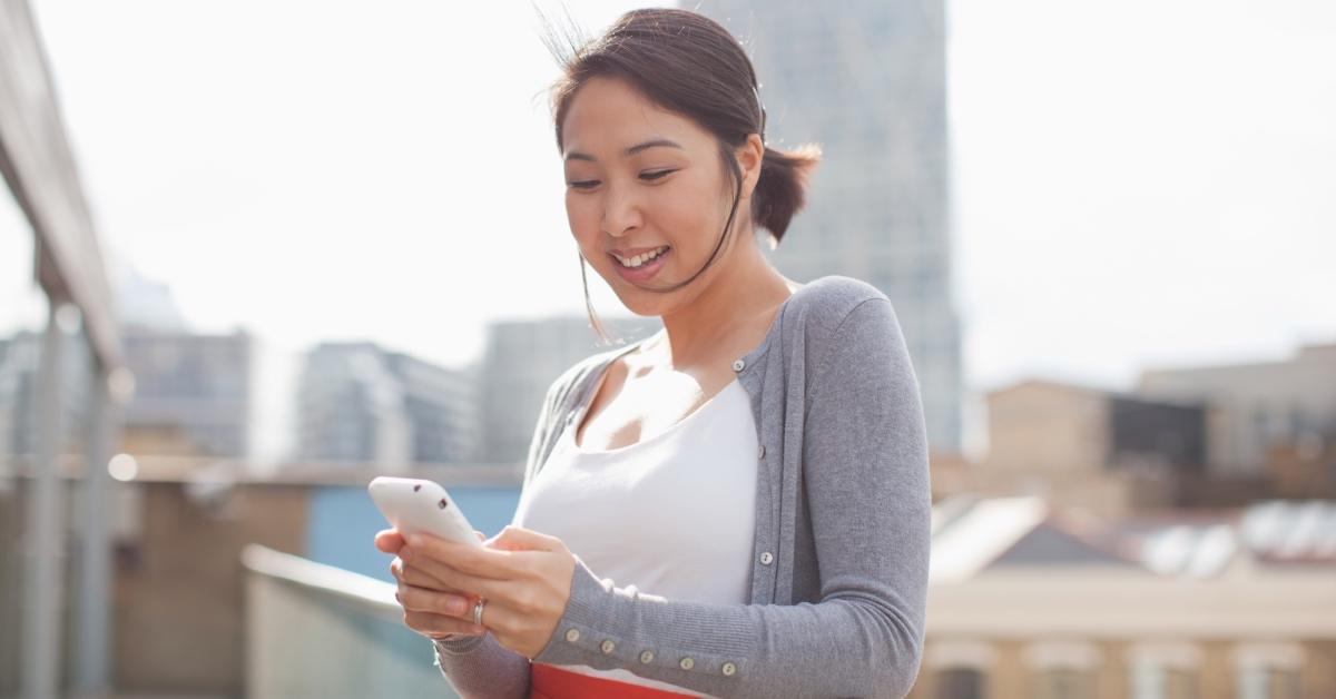 A woman typing on her phone