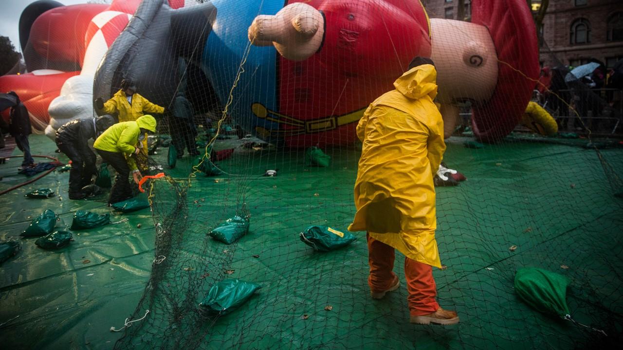 Workers filling a balloon with helium for the Macy's Thanksgiving parade