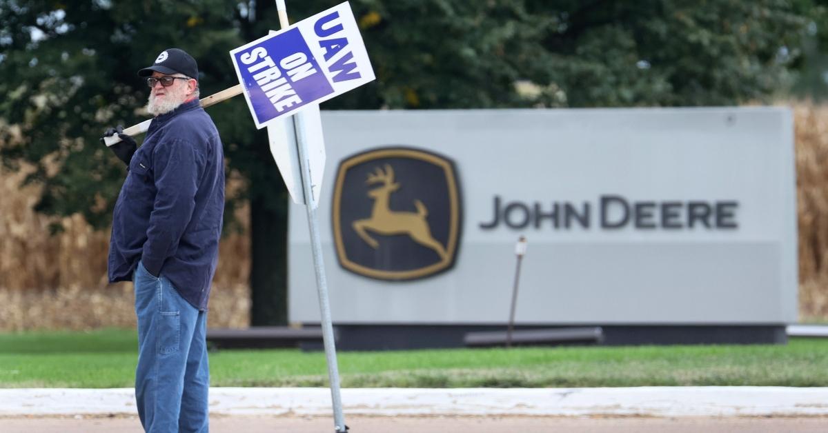 John Deere worker holding a picket sign