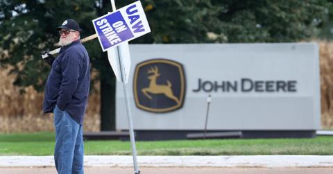 John Deere worker holding a picket sign