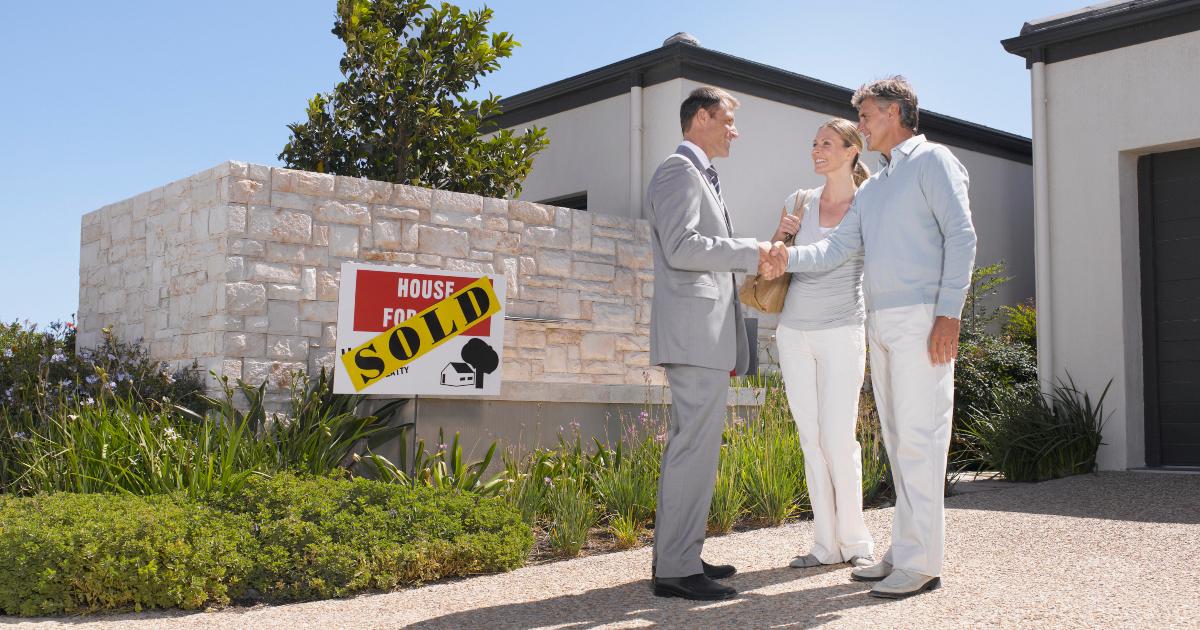 A couple talking to a realtor