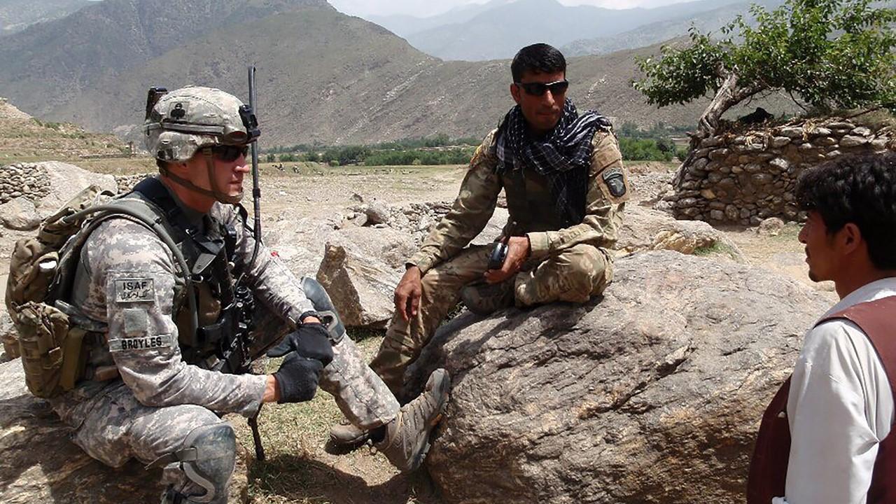 U.S. solider talking to an Afghan solider and civilian