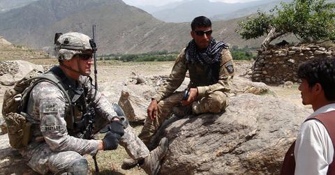 U.S. solider talking to an Afghan solider and civilian