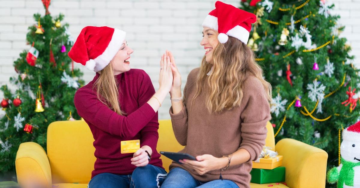 Two women using a credit card to shop online