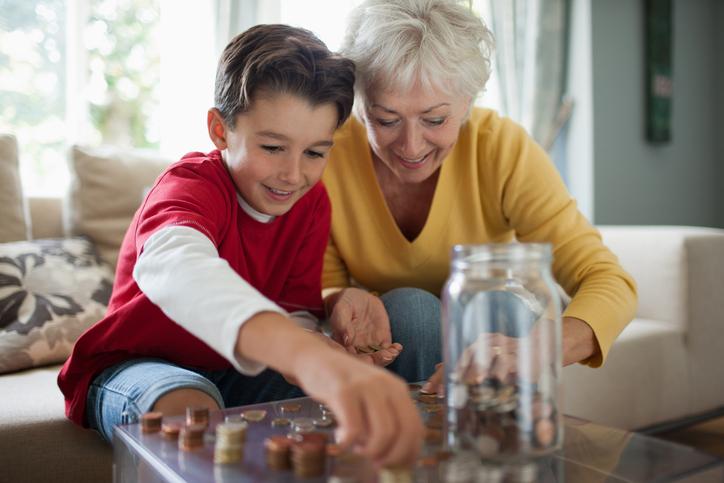 A boy and his grandmother examining coins