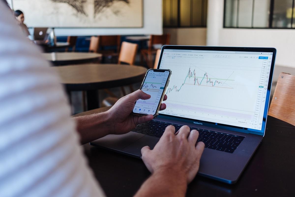 Businessman checking stock market graph