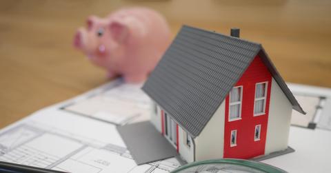 A small model house on blueprints