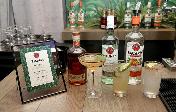 A cocktail menu, cocktails, and bottles of Bacardi products