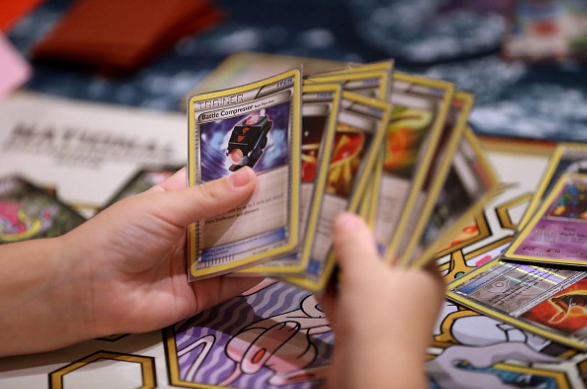 A boy's hand holds Pokémon cards at the Pokémon World Championships in San Francisco