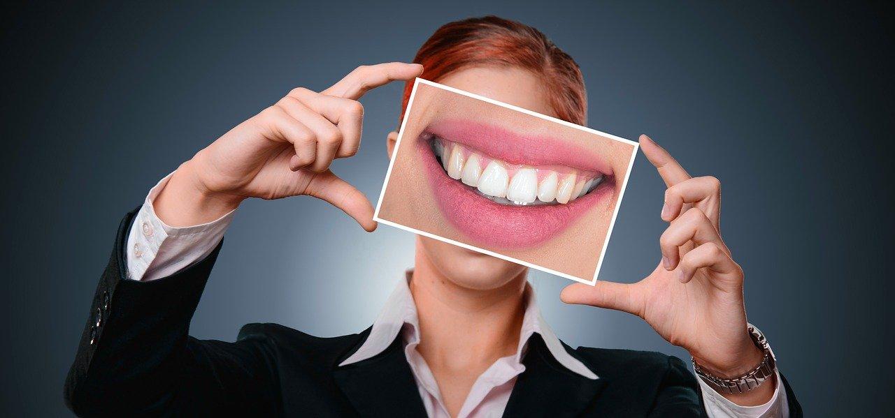 A person holding a photo of a smile