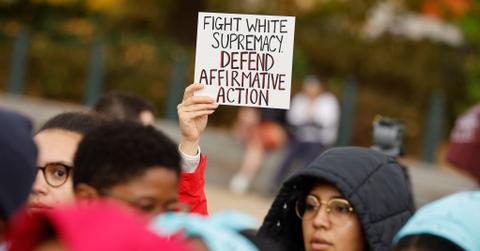 A protestor holding a sign about affirmative action