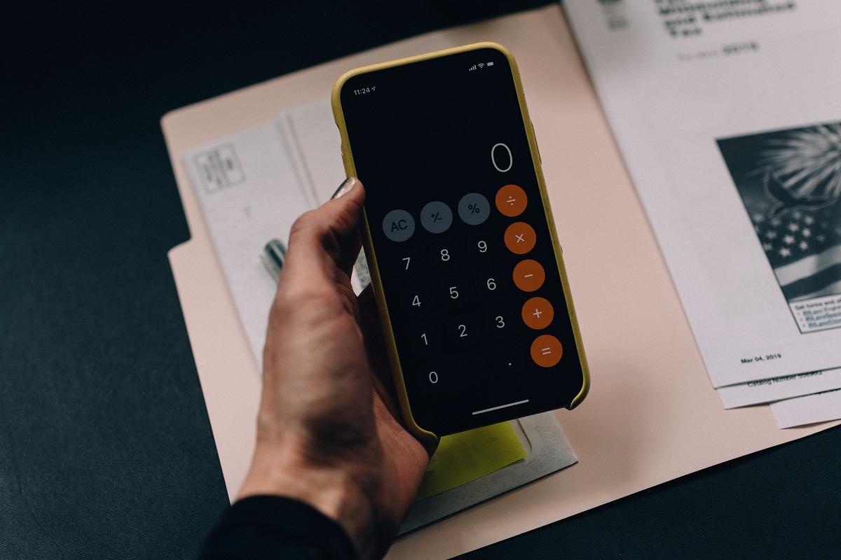 A woman using a calculator to determine her tax refund