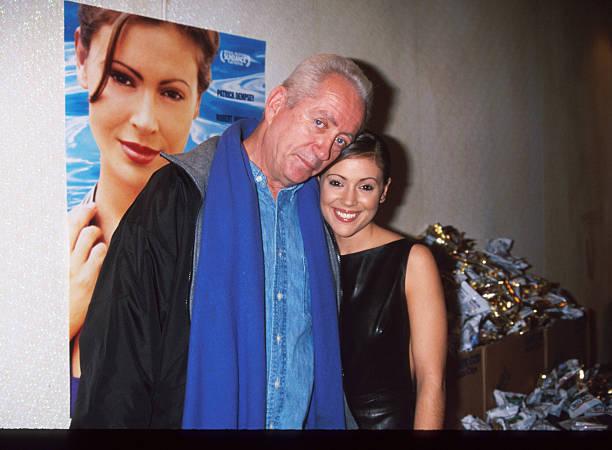 Director Robert Downey Sr. stands beside actress Alyssa Milano at the premiere of "Hugo Pool" December 3, 1997 in New York City. The movie is about a Los Angeles pool cleaner who falls in love with a man dying of Lou Gerhig's Disease. 