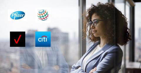 A woman looking out a window and company logos