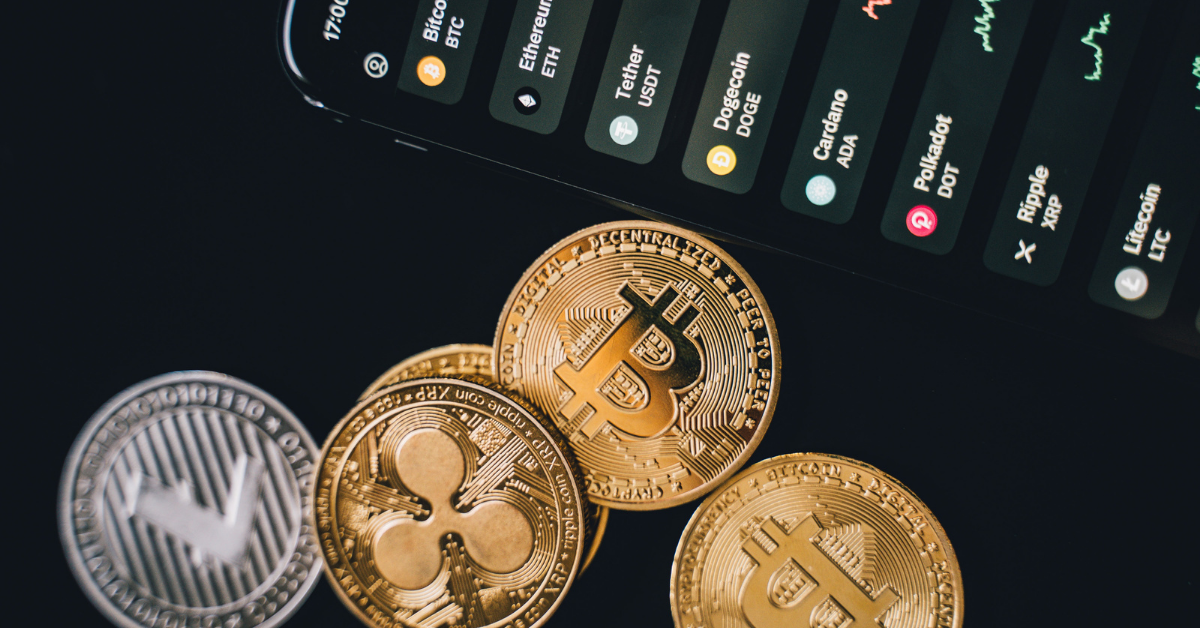 Cryptocurrency coins near a smartphone with data