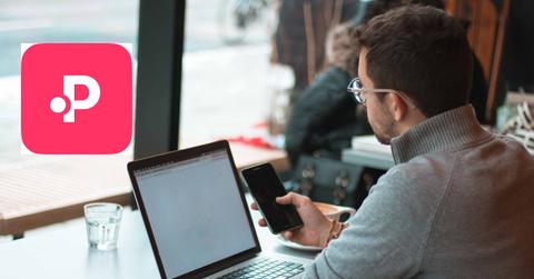 A person using a laptop in a café