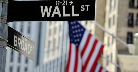 Wall Street sign and American flag