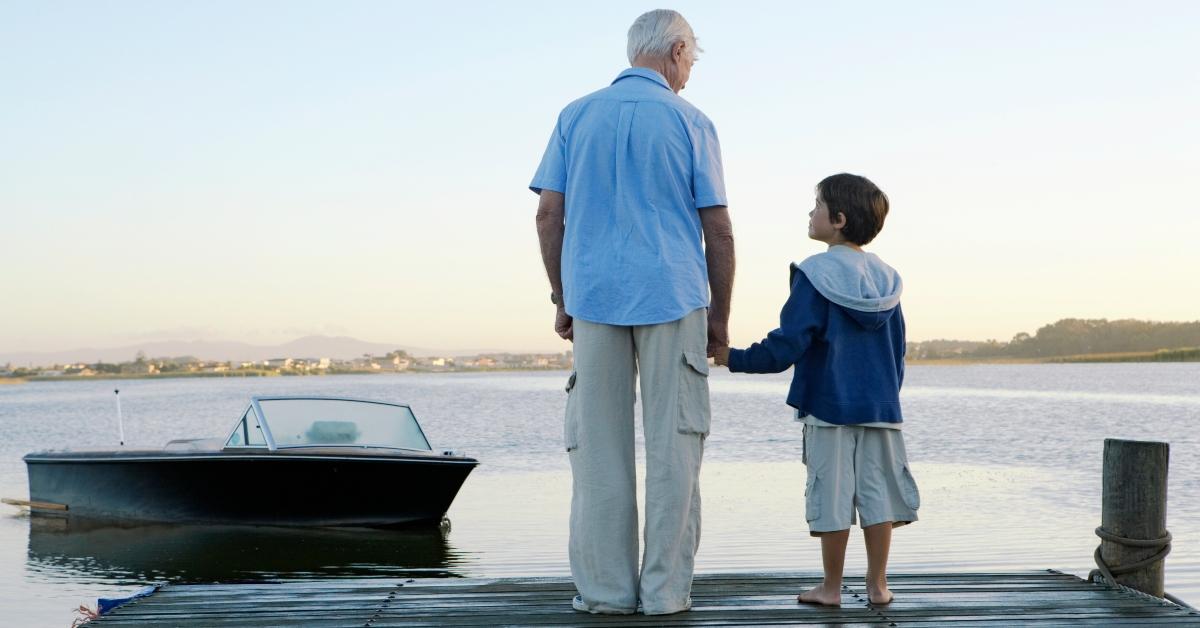 Grandfather standing on a dock with his grandson