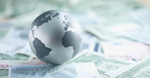 Globe resting on currency