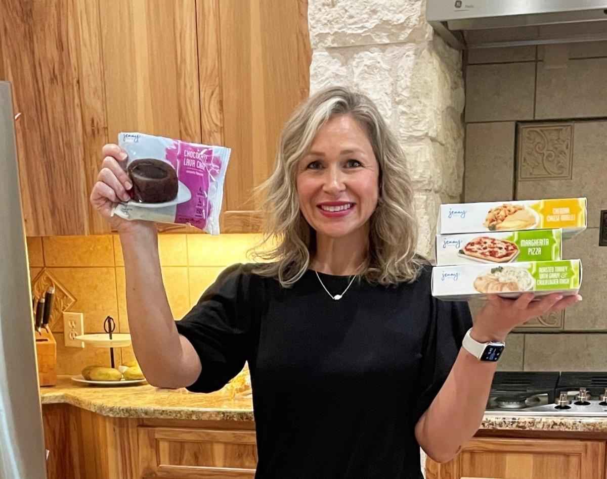 A woman holding Jenny Craig packaged foods