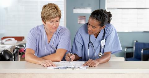 Nurses looking at PSLF waiver paperwork